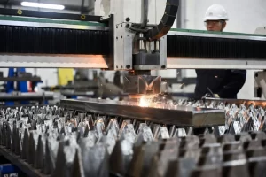 Fiber laser cutting manganese steel plate in a modern sheet metal factory